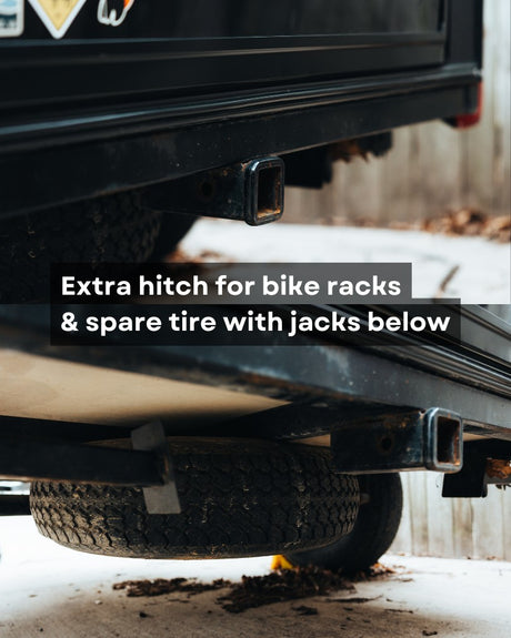 RV rental utility: Two hitch receivers (one for bike racks), and a spare tire with jacks below.