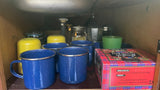 Compact RV kitchen storage: Blue mugs, tea, and coffee supplies ready for your rv rental adventure.