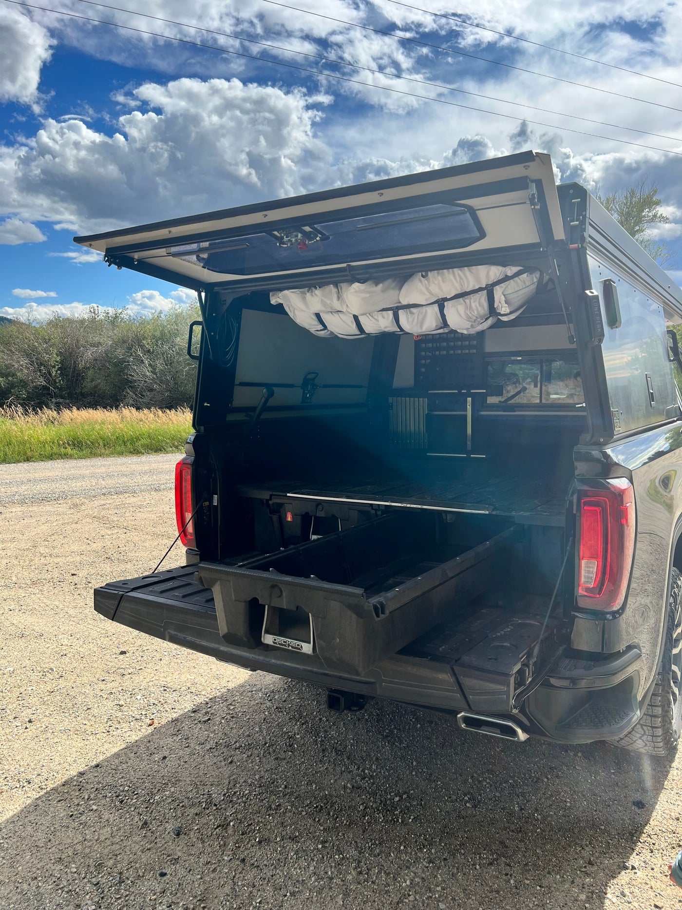 Adventure-ready truck with a custom overland camper and DECKED storage system, perfect for an rv rental experience. — photo 12