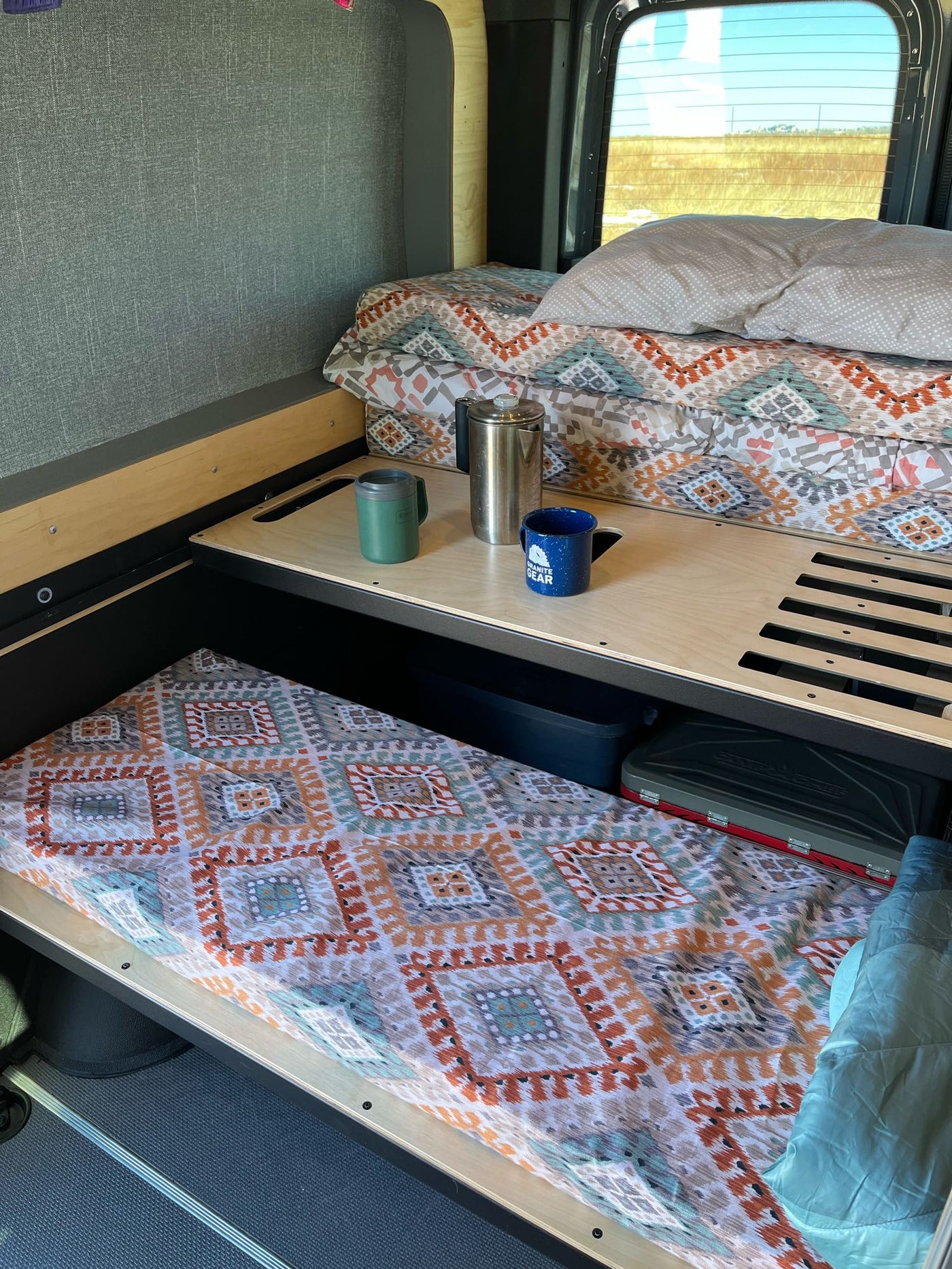  kitchen gear & storage in a vast landscape.|Inside a comfortable RV rental van with multiple seats — photo 12