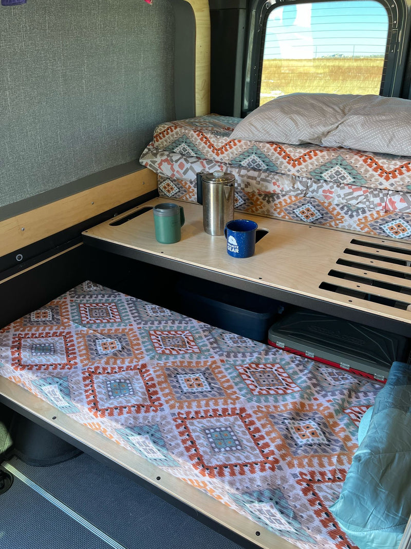  kitchen gear & storage in a vast landscape.|Inside a comfortable RV rental van with multiple seats — photo 12