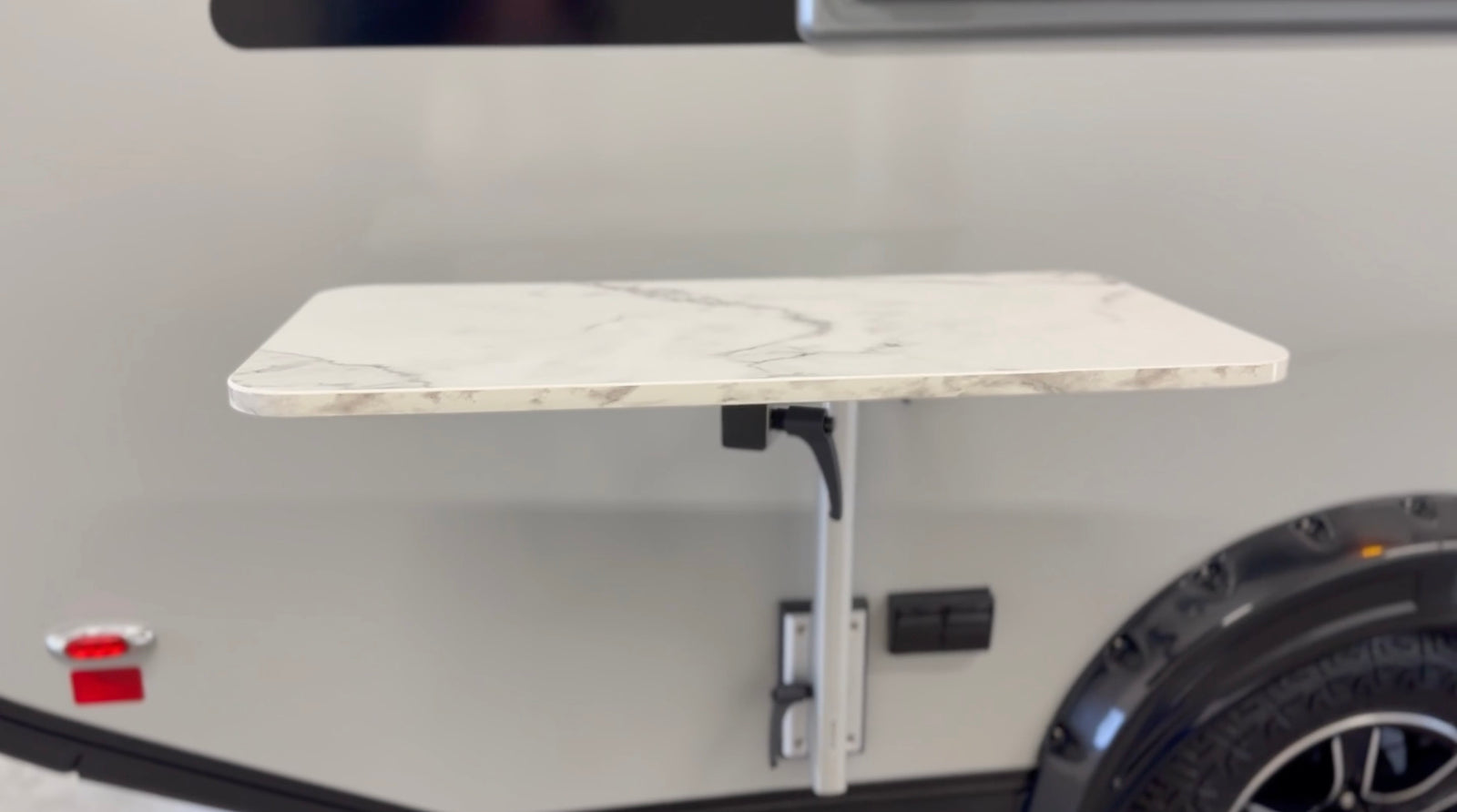 Convenient exterior folding table on an RV rental, perfect for camping and outdoor dining.