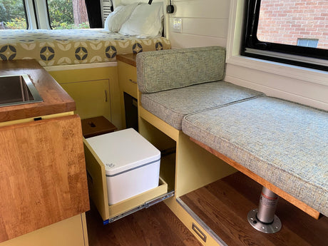  and adjustable table. Features compact kitchenette