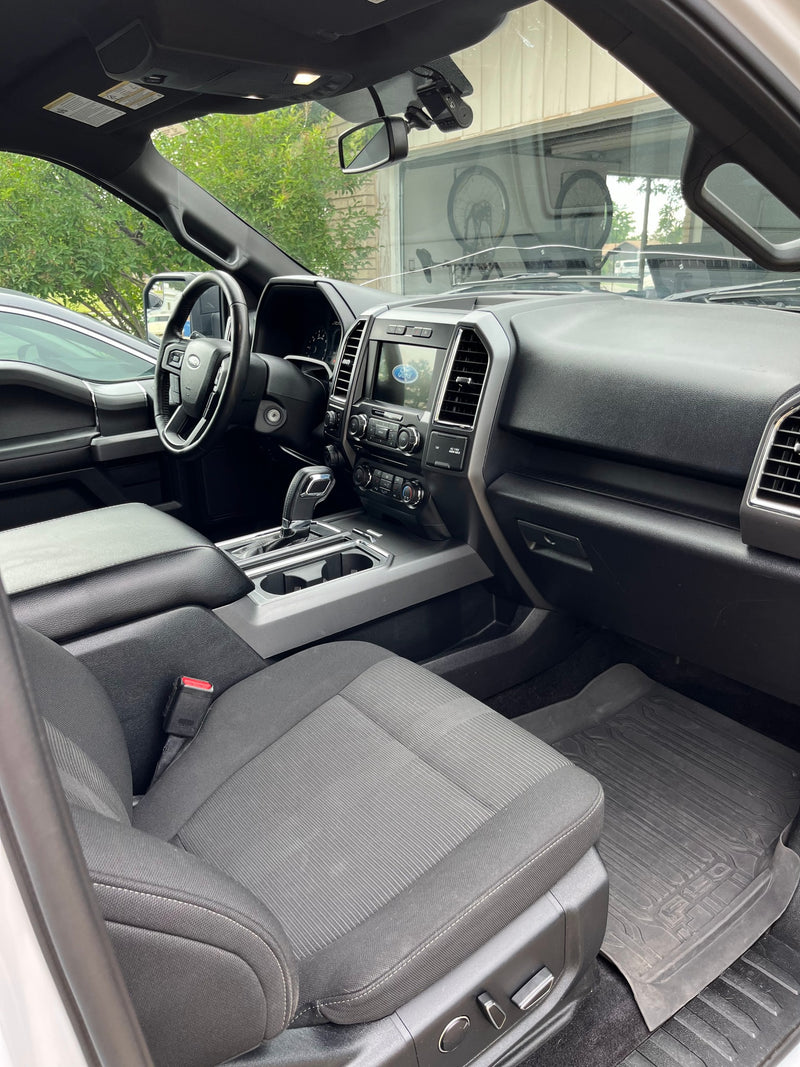 Modern Ford truck interior: dashboard, steering wheel, cloth seats. Consider this comfortable ride for your next RV rental adventure. — photo 14