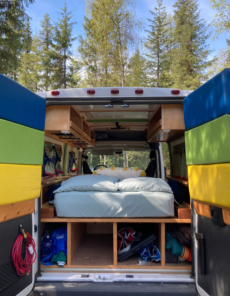 Back of an RV rental: features a comfy bed, overhead cabinets, and under-bed storage. Ideal for road trip adventures! — photo 5