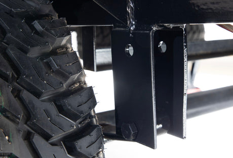 Close-up: rugged tire tread & sturdy black frame, vital for a robust RV rental trailer.