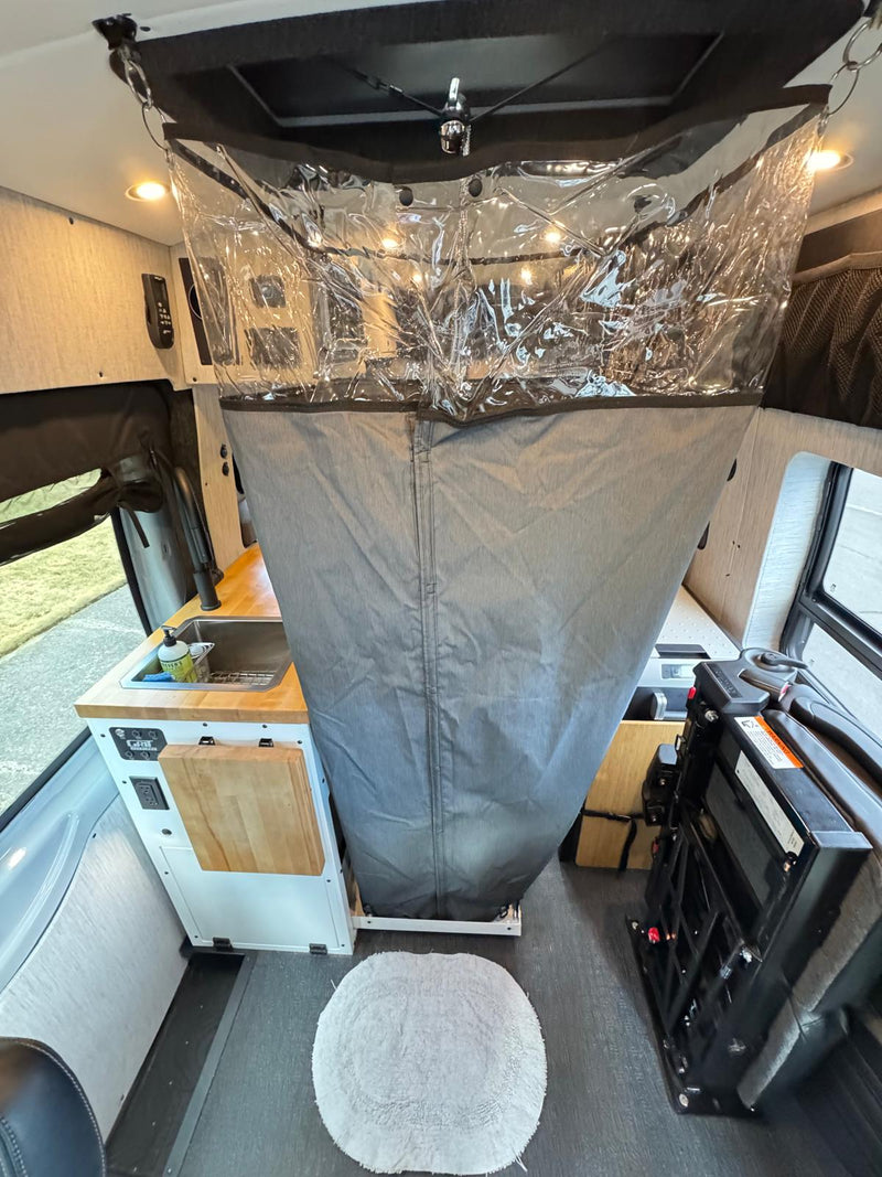  and a picturesque view of the trees outside.|Inside a spacious RV rental: modern kitchen setup — photo 9