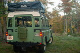 This classic green Land Rover with a CVT rooftop tent is ready for an RV rental outdoor adventure.