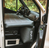 RV rental comfort: Luno inflatable mattress in a van's front cabin, creating a bed for mobile camping & road trips.