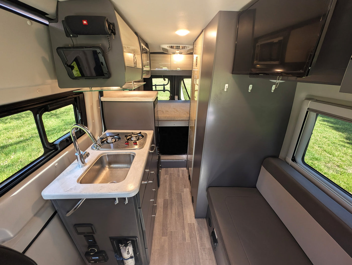  a great RV rental. Front view on grass with trees.|An RV rental's central control hub: a tablet showing climate — photo 18