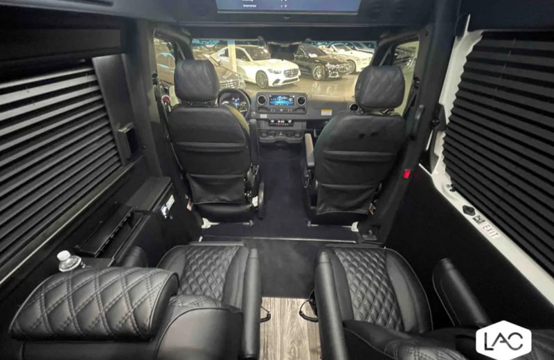  featuring diamond stitching and armrests.|Inside a premium RV rental: Mercedes-Benz Sprinter driver's area featuring quilted leather and high-tech dashboard.|Inside an RV rental — photo 4