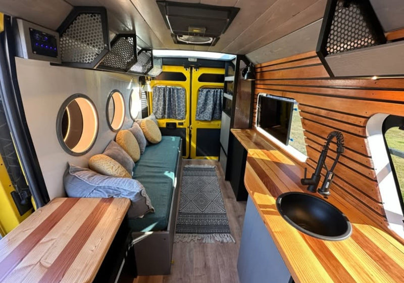 Efficient RV rental interior with a modern kitchen, comfy living area, and illuminated portholes. Perfect for travel adventures. — photo 5