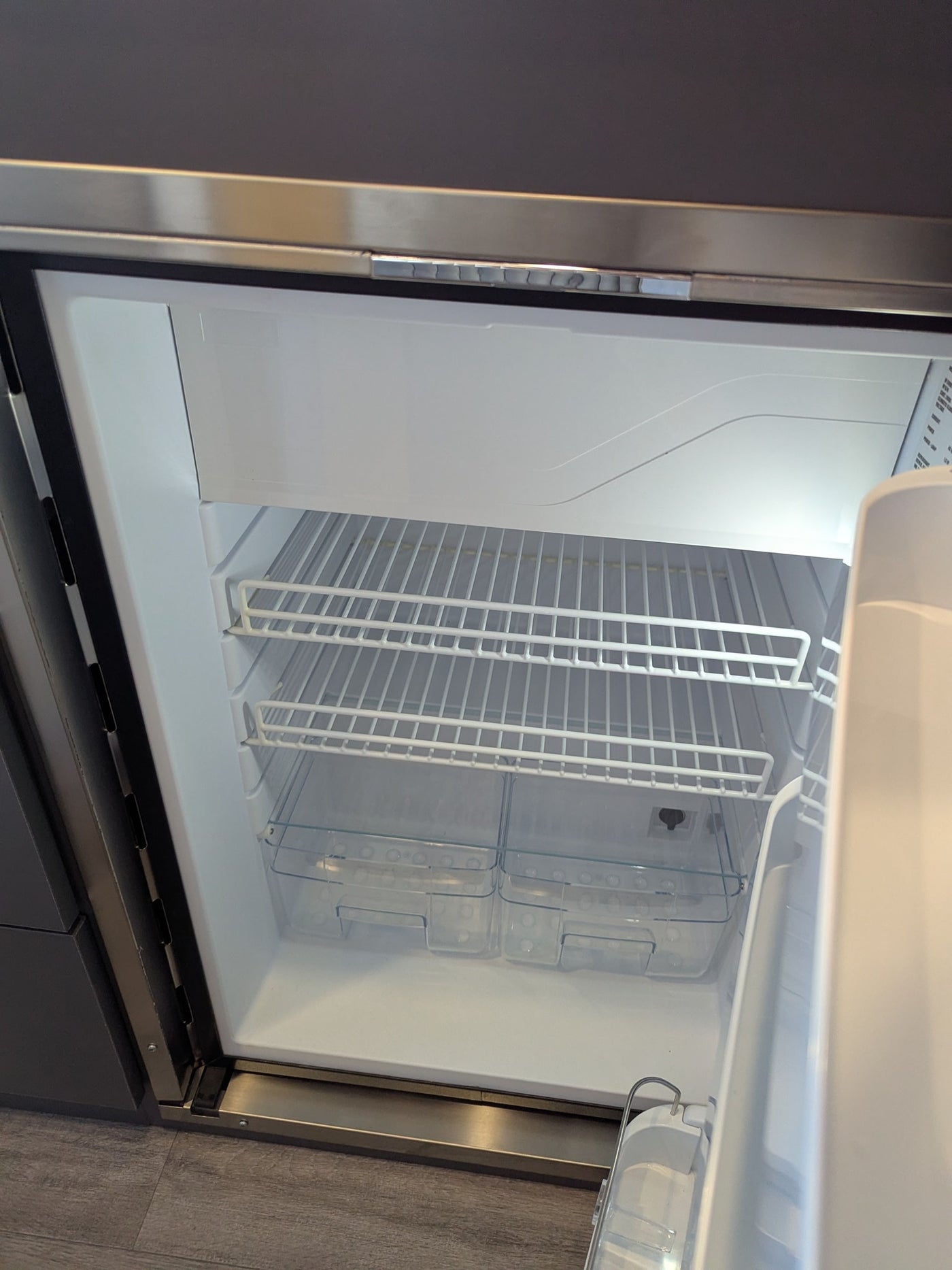 Clean, empty RV rental refrigerator, ready for your trip! Features wire shelves and crisper drawers. — photo 7