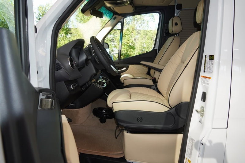  perfect for comfortable travel.|Explore this opulent rv rental: custom van interior with quilted cream leather captain's chairs & controls.|Experience luxury in this RV rental. Sumptuous cream seats — photo 19