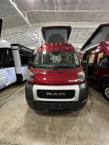 Red Winnebago Ram ProMaster pop-top camper van, ideal for your next RV rental adventure.