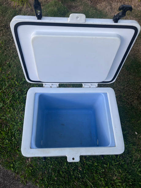 Durable white cooler, open to its light blue interior, perfect for any rv rental or camping adventure.