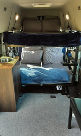 This RV rental features comfortable bunk beds and a compact kitchenette with a sink, perfect for camper travel.