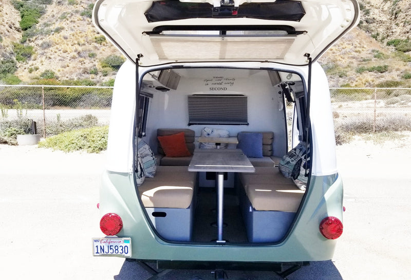 Inside a compact rv rental: open rear hatch reveals a cozy dinette, ready for your next road trip adventure. — photo 11
