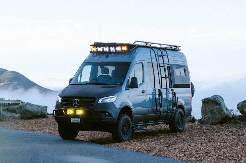  and cupholders. Road view ahead.|This rugged Mercedes Sprinter camper van rv rental is parked on a sandy beach — photo 6