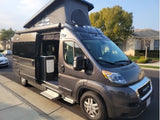 Dark gray RAM ProMaster pop-top camper van rv rental, side door open with steps extended, ready for adventure.