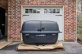 A large gray LetsGoAero cargo carrier for RV rental storage, shown on a pallet.