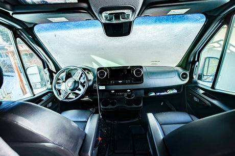 RV rental van interior with frosted windshield, dashboard, and front seats, hinting at a cold journey.
