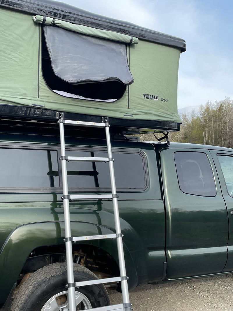 Green pickup truck with a Thule Tepui rooftop tent and ladder, offering a unique RV rental camping experience. — photo 6