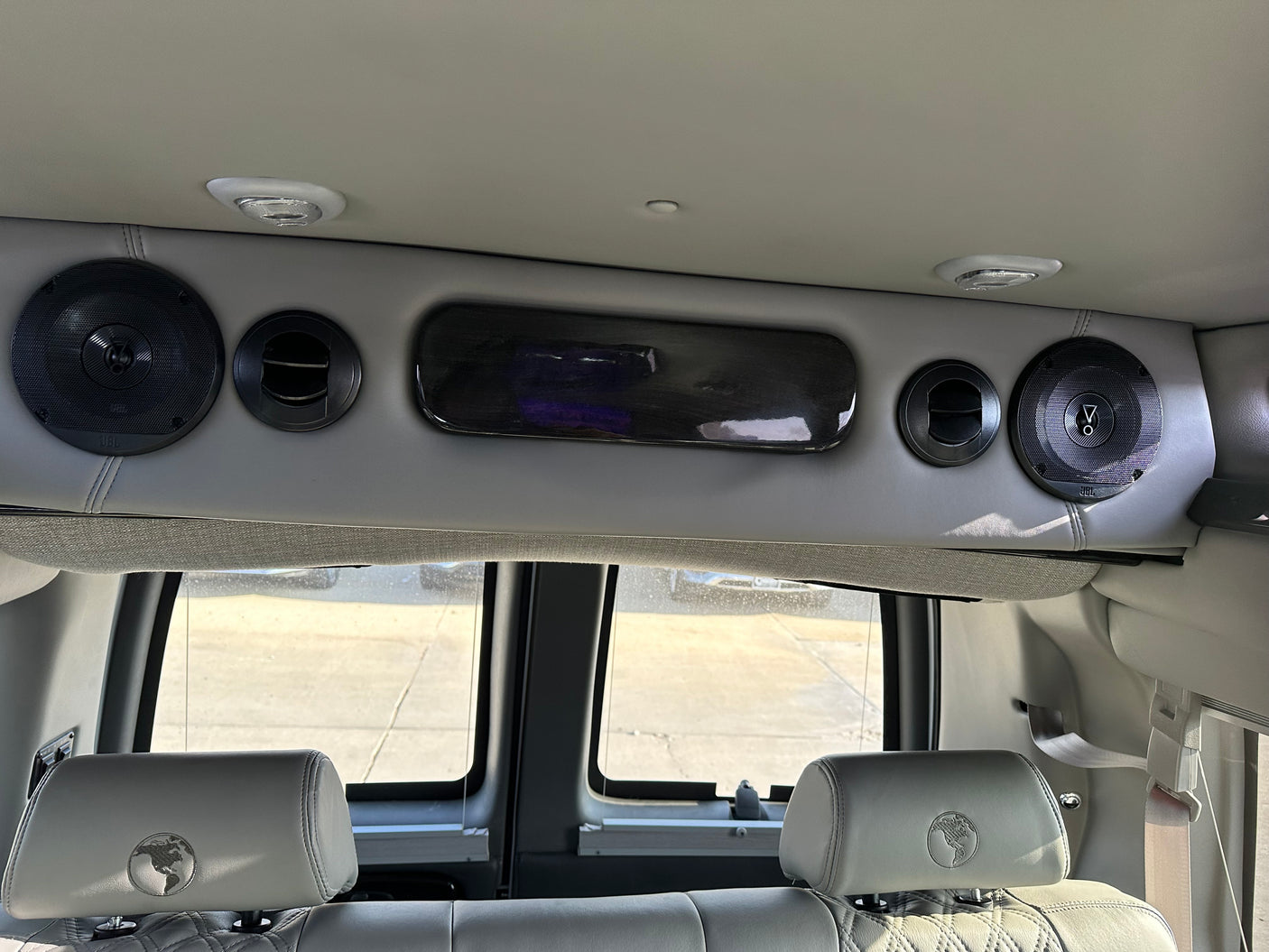 Spacious RV rental interior: featuring premium JBL speakers, comfort seating with globe headrests, and cabin amenities.