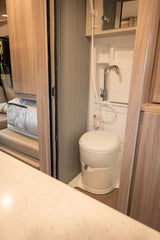 Inside an RV rental: a functional wet bath with an integrated toilet and shower for convenient road trips.