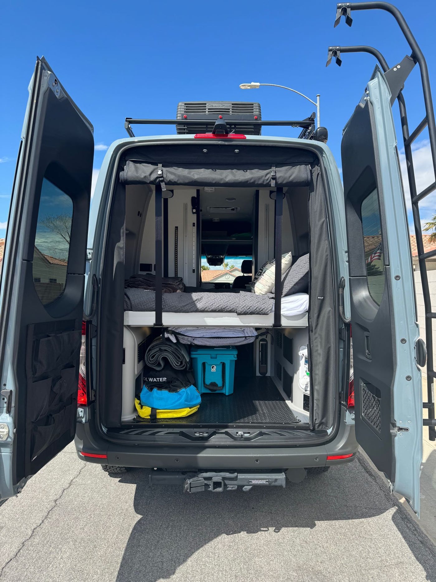 Grey camper van (RV rental) with awning & open doors — photo 9