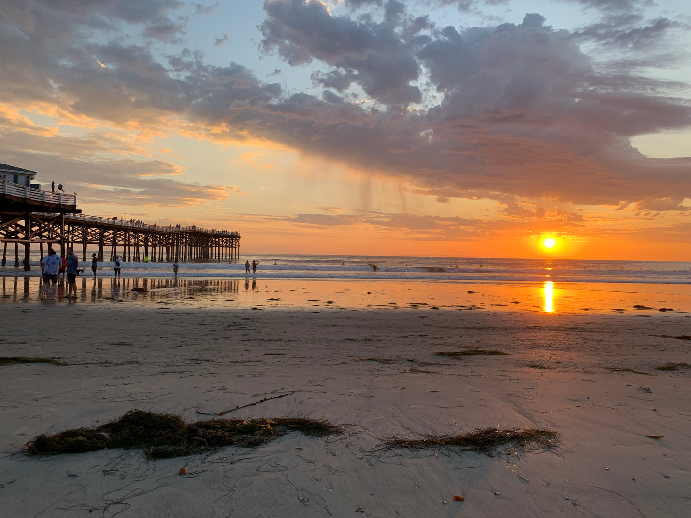 Stunning beach sunset with a pier & ocean views. Imagine this scenic stop on your RV rental adventure!