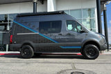 A custom gray Shepard Sprinter van, equipped for adventure with off-road tires. Great for an rv rental experience.