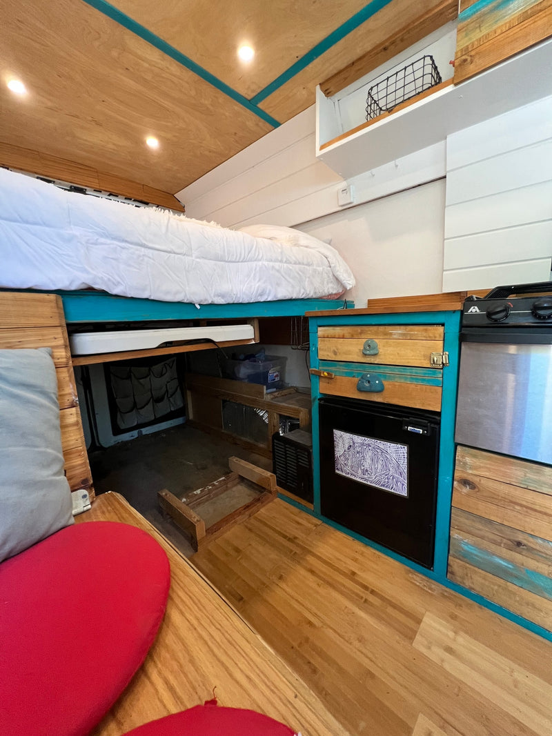  and unique turquoise and wood decor for adventurous travels.|RV rental interior kitchen view — photo 5