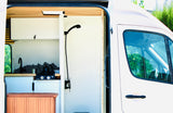 This RV rental features a modern campervan kitchen with a sink, stovetop, and a compact shower, ideal for mobile living.