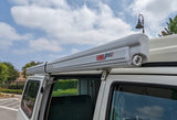 White camper van equipped with a Fiamma F45S roof awning, perfect for your next RV rental outdoor adventure.