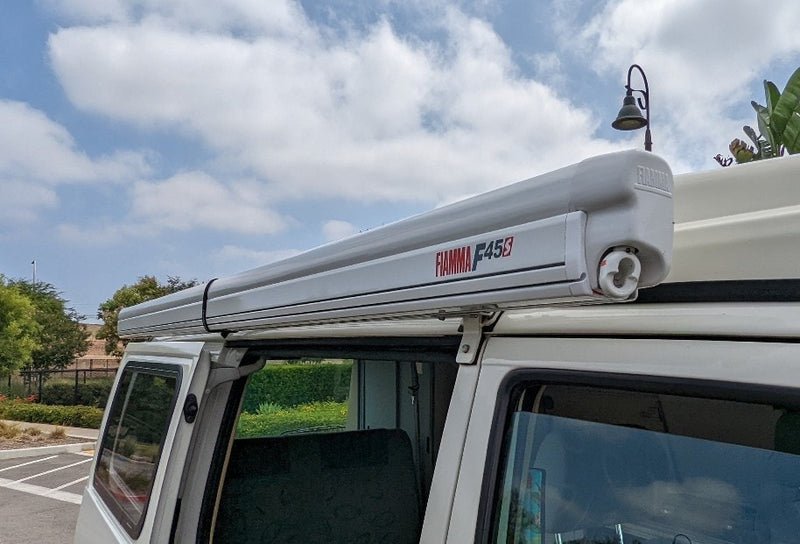 White camper van equipped with a Fiamma F45S roof awning, perfect for your next RV rental outdoor adventure. — photo 10