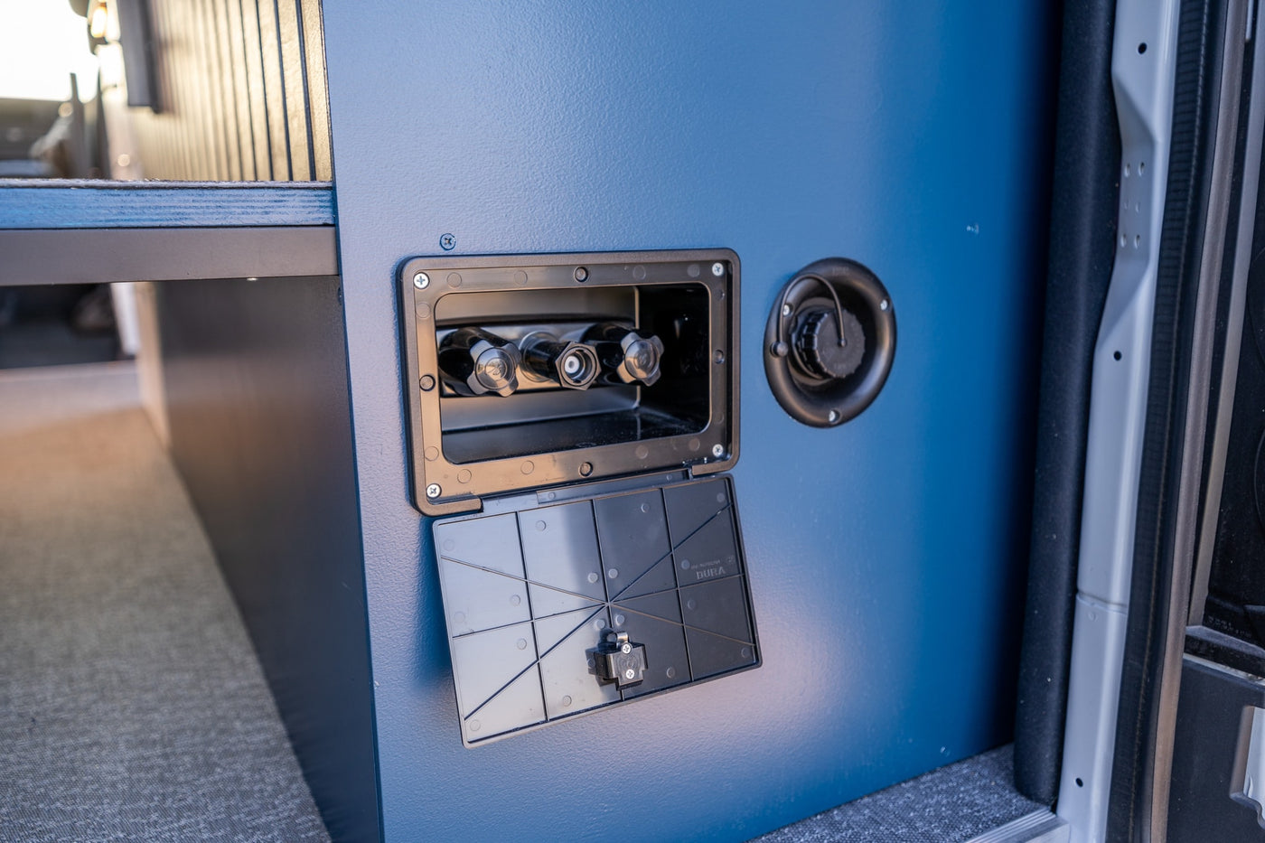 RV rental's blue exterior with an open outdoor shower hookup & fresh water fill station for convenience. — photo 14