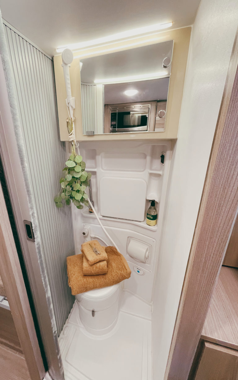  grill. Perfect for camping!|Inside a modern RV rental: a bright living area with dining table for two — photo 4