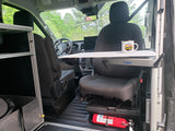 This RV rental's front cabin interior features a practical Lagun table, swiveled passenger seat, and fire extinguisher, perfect for van life.