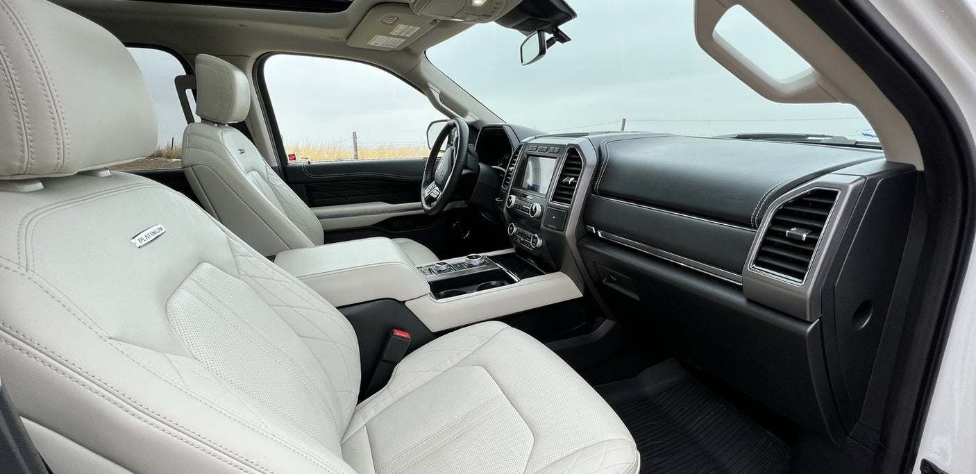 Explore the plush white leather interior of this large SUV, a perfect companion for your next RV rental adventure.