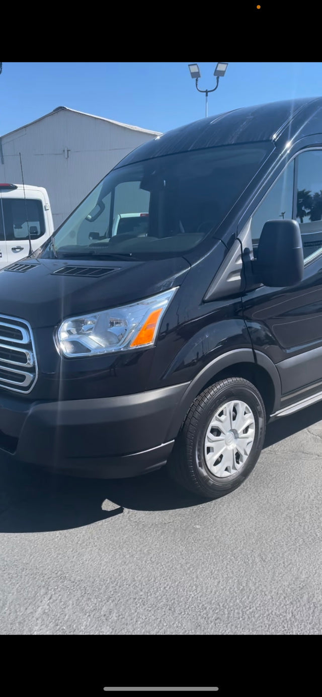  and ample lighting.|Plush black leather seats with seatbelts and built-in cup holders inside an RV rental