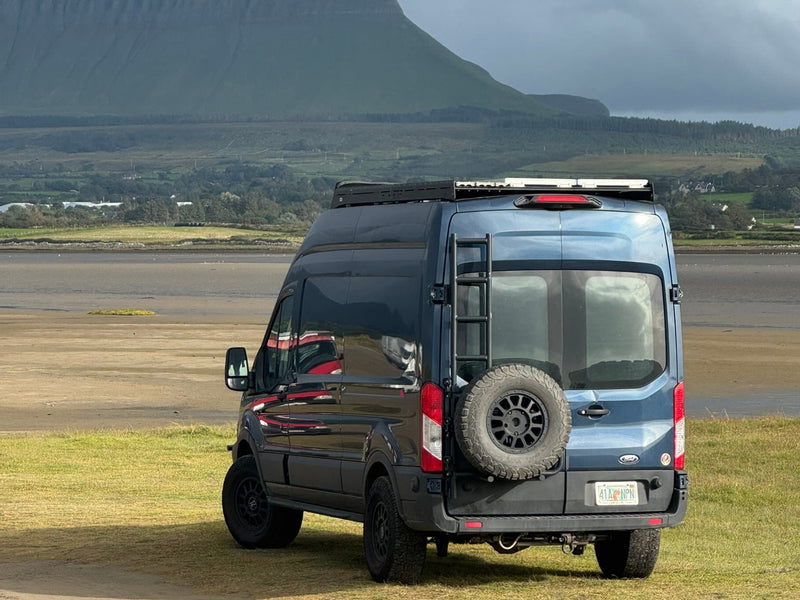 Dark blue RV rental camper van with ladder & spare tire — photo 1