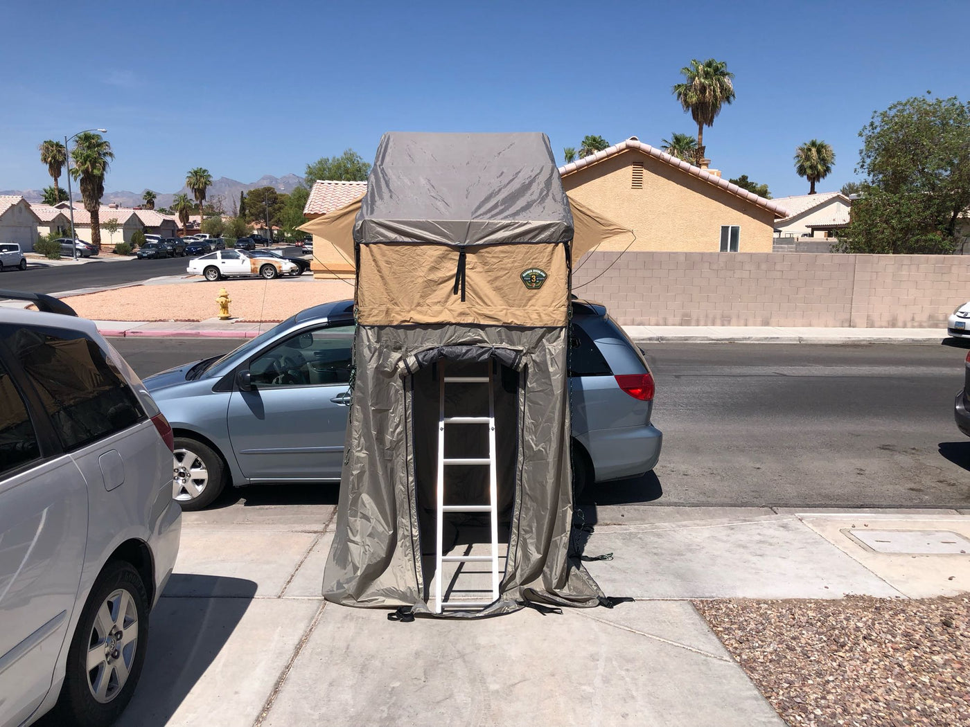  ideal for camping and travel adventures.|A minivan with a deployed rooftop tent — photo 5