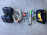 RV rental accessories: tool bag, screwdrivers, lug wrench, fuses, extension cord, and leveling blocks.