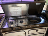 This Westfalia RV rental features a compact kitchen with a two-burner stove and sink, perfect for camping.