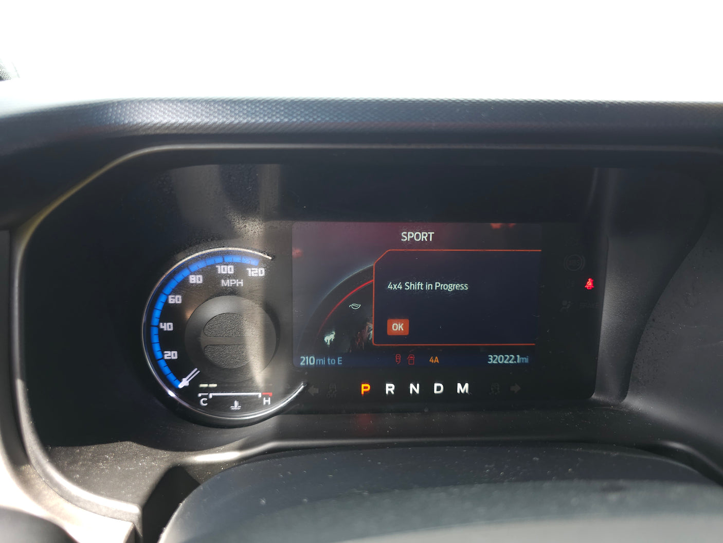 RV rental dashboard displays '4x4 Shift in Progress' message, SPORT mode, and 32022.1 miles. Vehicle is in Park.