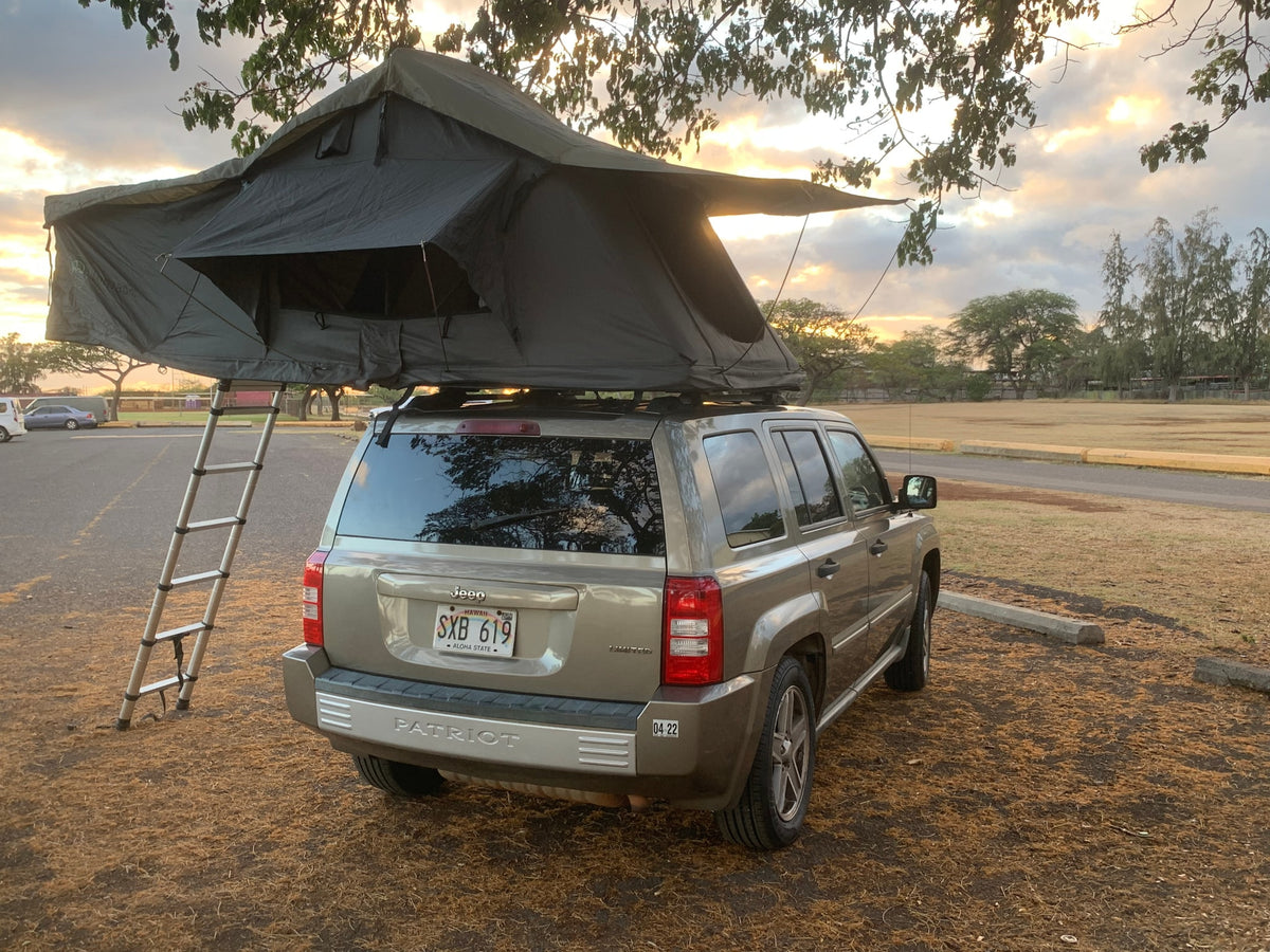 Tan Jeep Patriot with roof-top tent and ladder setup at sunset. Perfect for an RV rental or car camping adventure. — photo 19