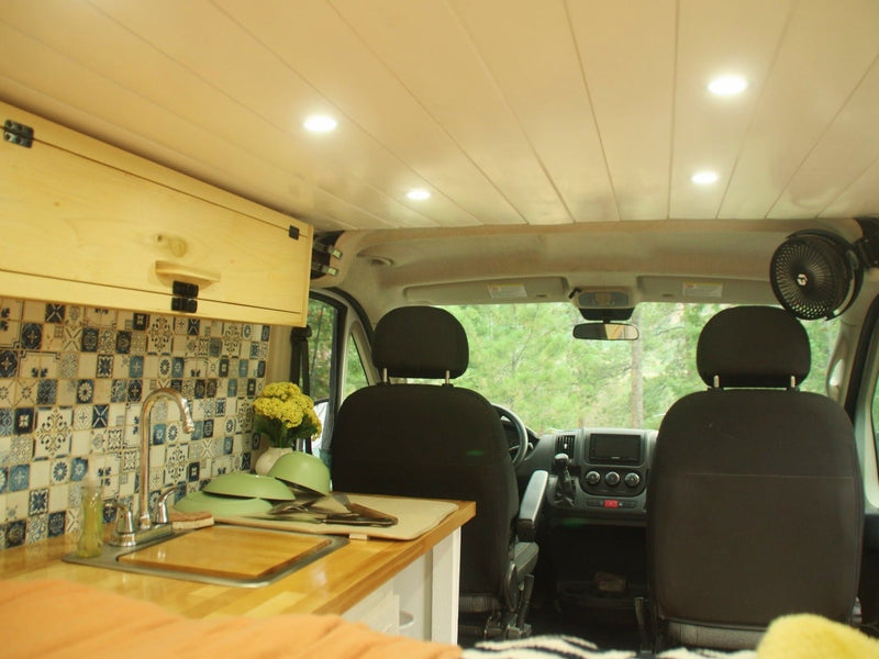  where friends are sharing an outdoor meal.|Two young adults smile inside a cozy rv rental camper van — photo 10