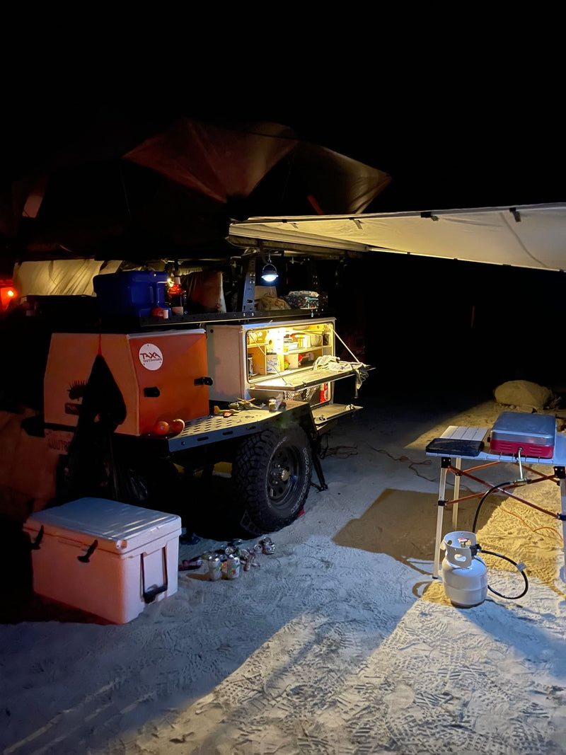  a compact alternative to an RV rental. Mountains & cloudy sky visible.|Nighttime camping setup with an RV rental camper — photo 7