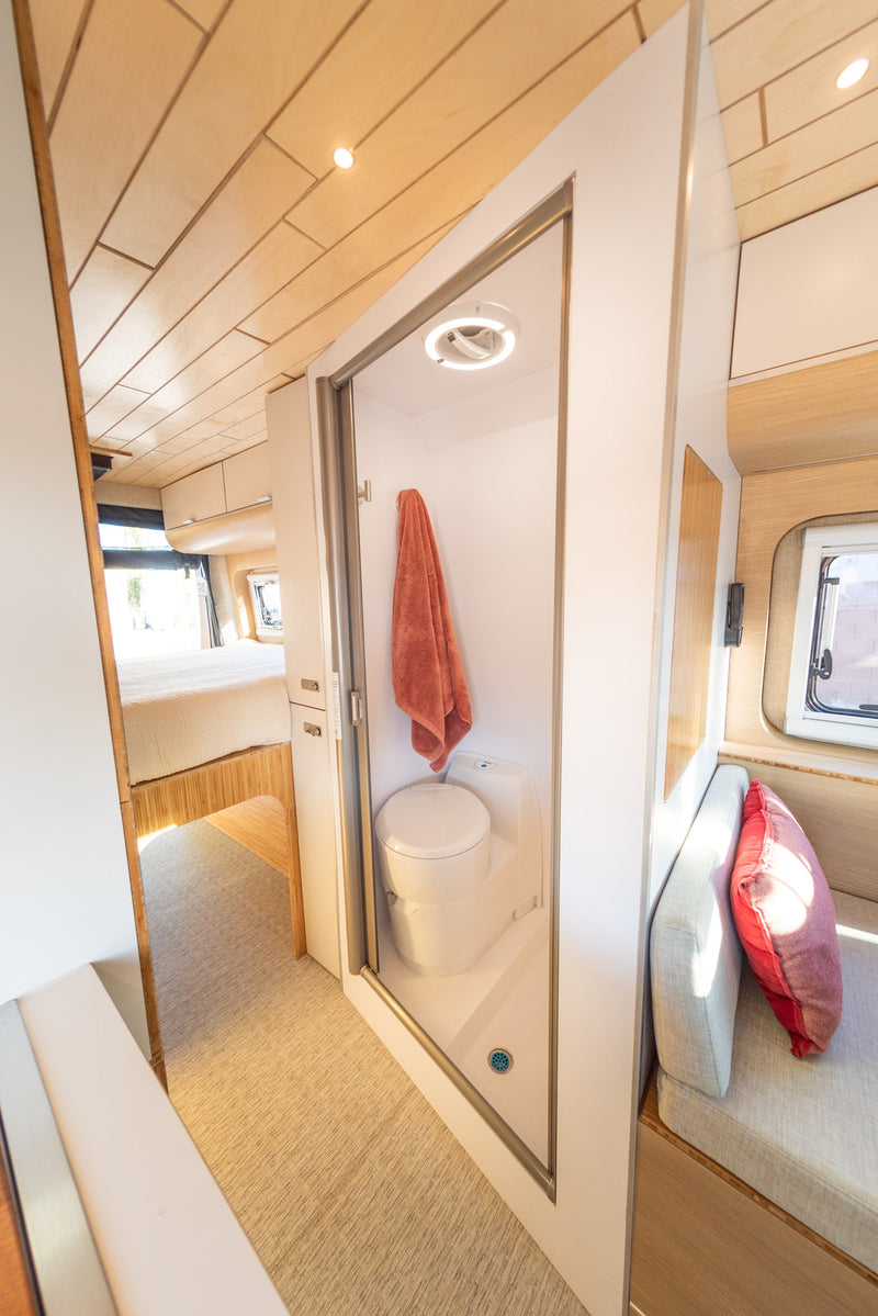  and large window.|Bright RV rental interior with a functional kitchen — photo 11